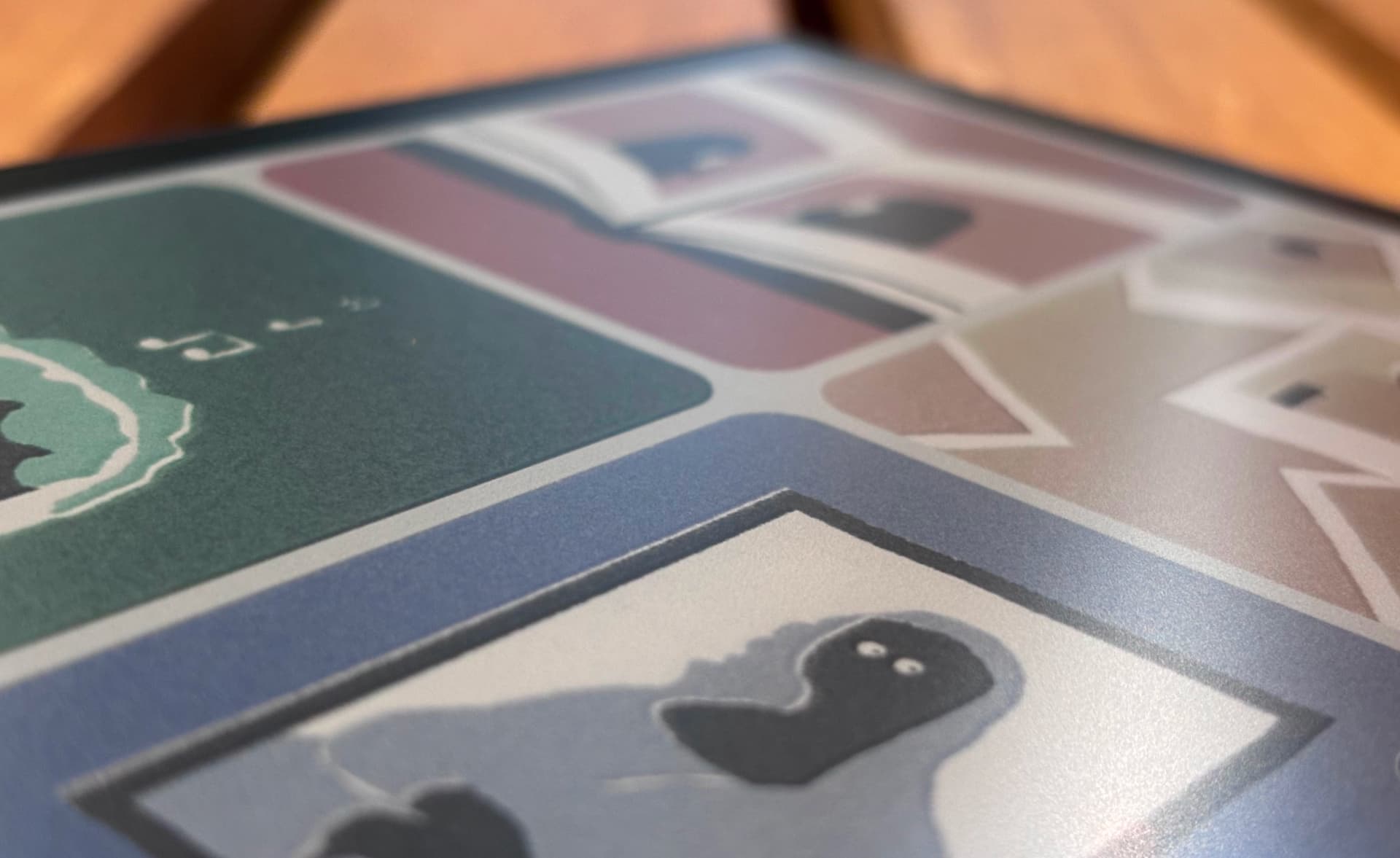 Close-up of Miniberry e-ink screen showing illustrations